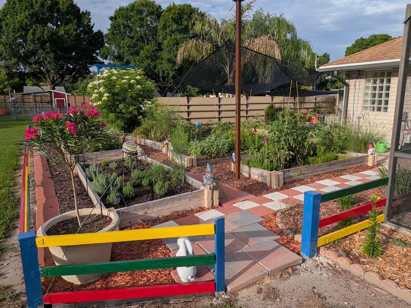 Rainbow-painted rails along raised garden beds